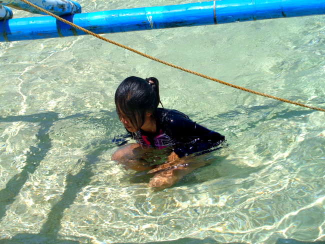 niece checking out puka shell beach boracay